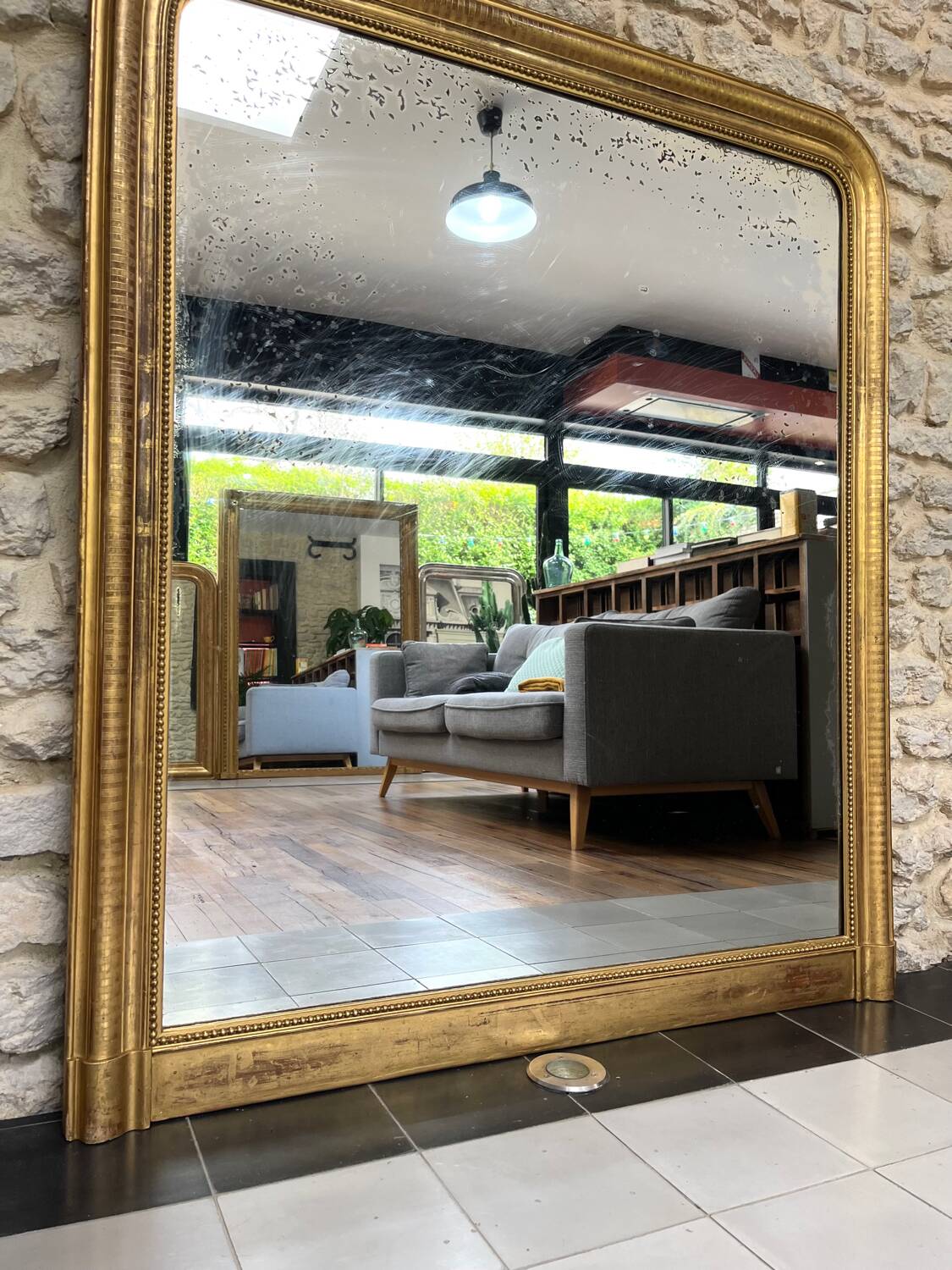 Louis-Philippe mantel mirror 133cm/115.5cm beaded gilded with gold leaf geometric decoration, late 19th century, heavily pitted and scratched glass, parquet on the back.