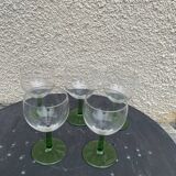 5 transparent glass glasses and green glass vase go