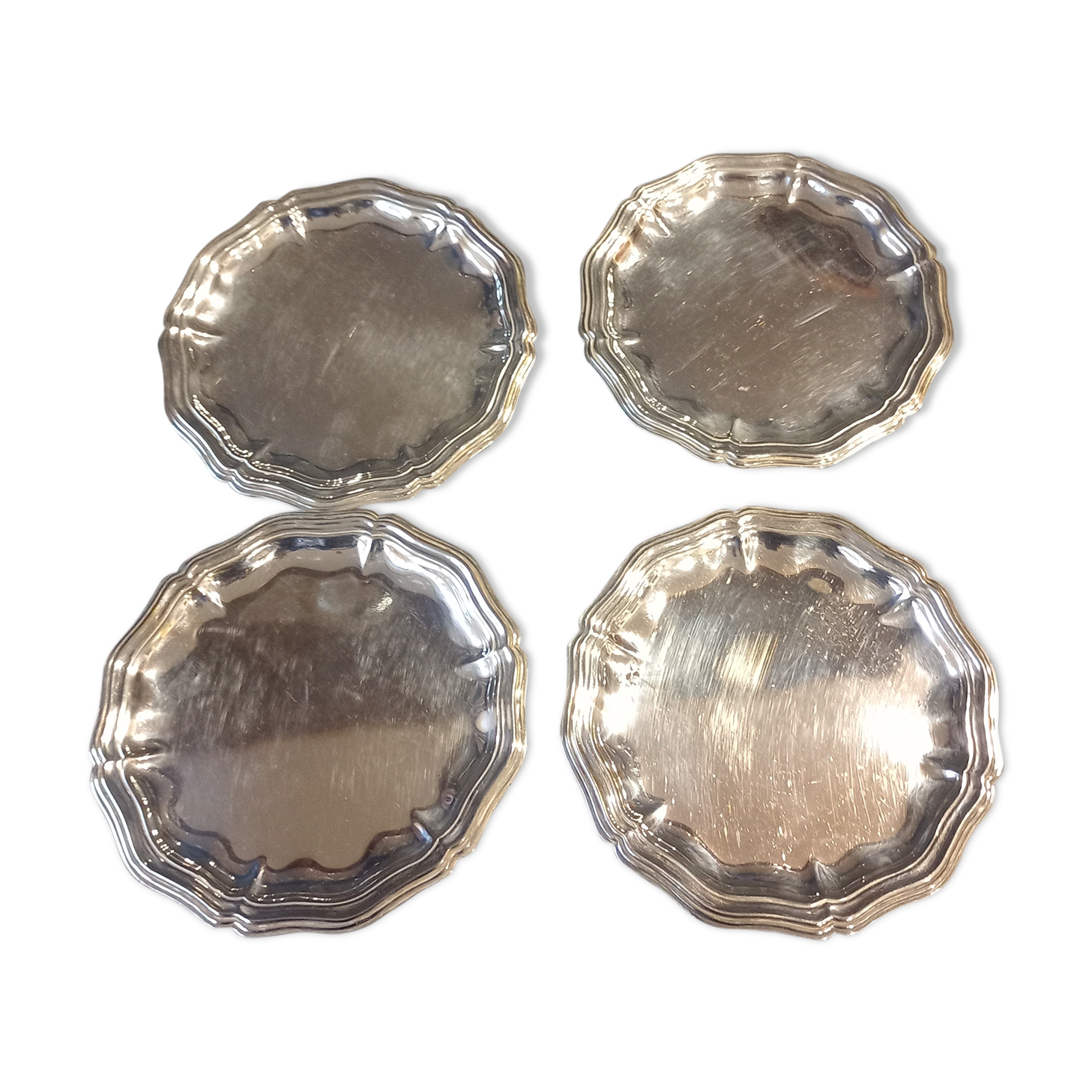 Four silver metal bottle bottoms