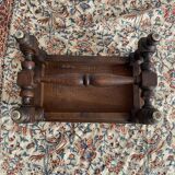 Low stool in carved wood