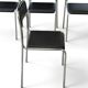 Bauhaus-style tubular steel chairs with black faux leather upholstery, Italian modernist dining room