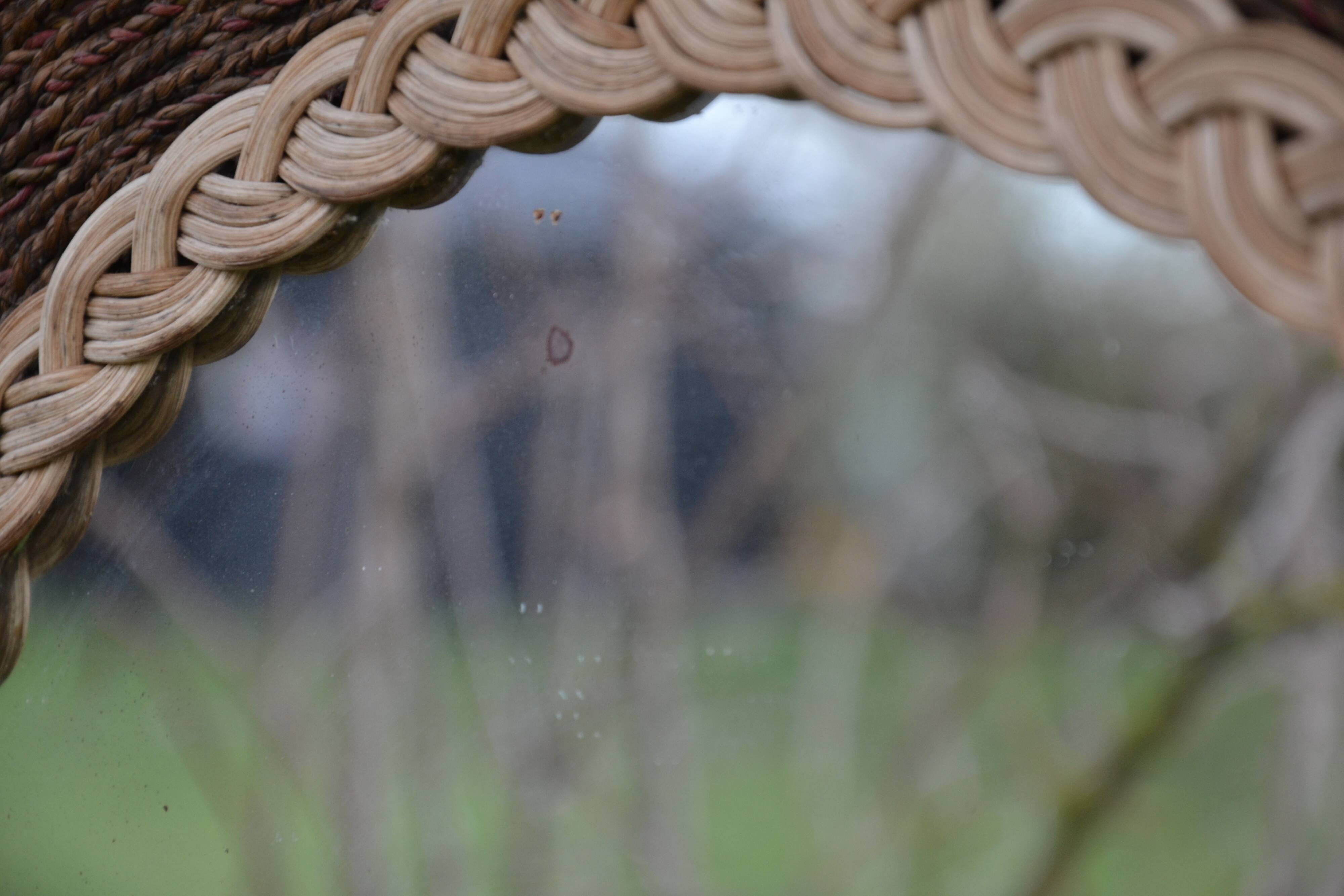 Round woven rattan mirror with rope from the 1970s.
