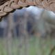 Round woven rattan mirror with rope from the 1970s.