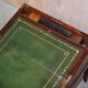 Antique hardwood military campaign desk with writing slope.