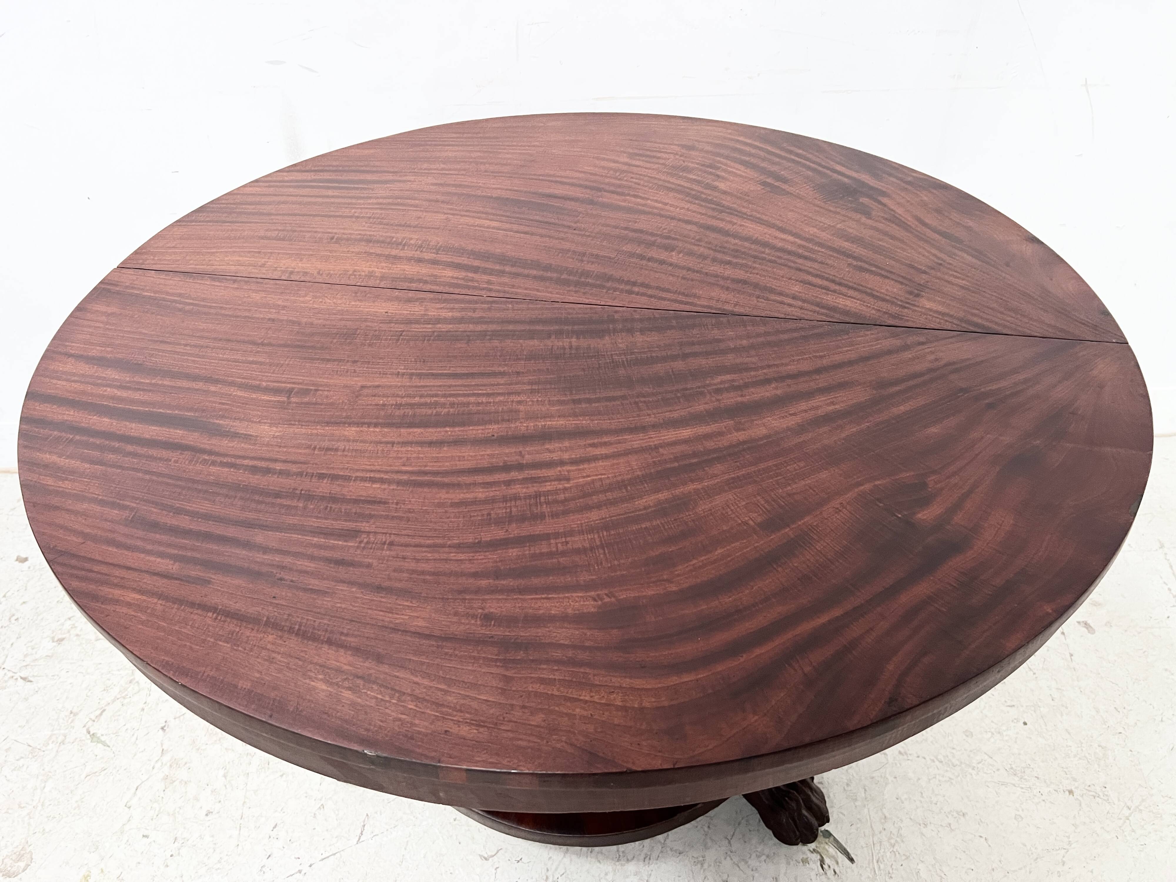 Empire style round table with claw feet, 19th century.