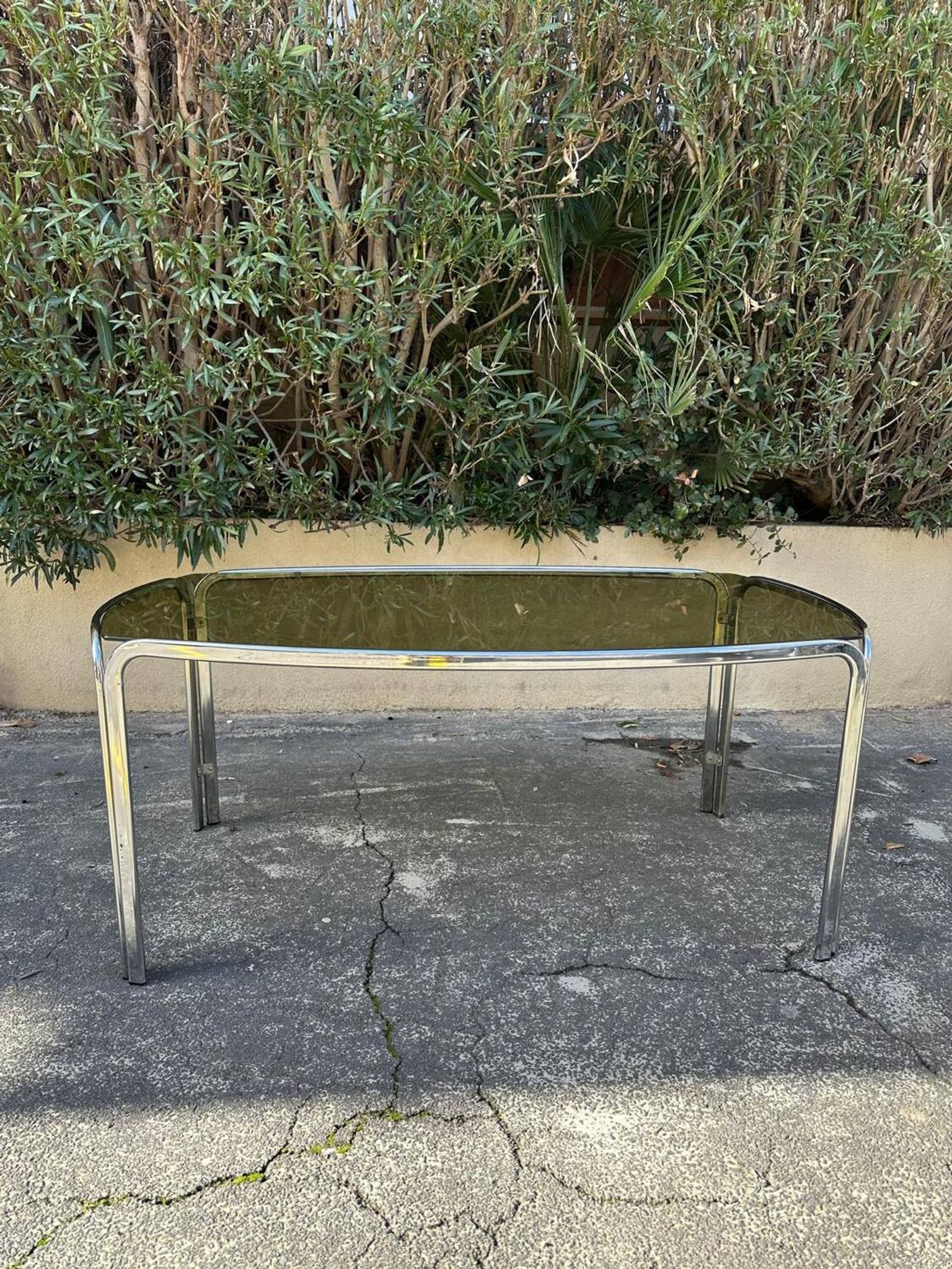 Vintage curved rectangular dining table in smoked glass and metal.