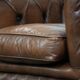 Brown cowhide leather chesterfield armchair  in English style on wheels