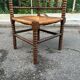 Brutalist corner chair in turned wood with straw bobbins, 1960.