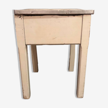 Small bedside table with wooden legs and metal-rimmed Formica lid tray