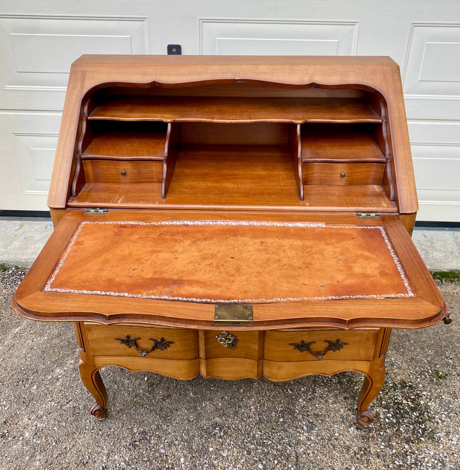 Louis XV style writing desk with a curved back.