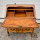 Louis XV style writing desk with a curved back.
