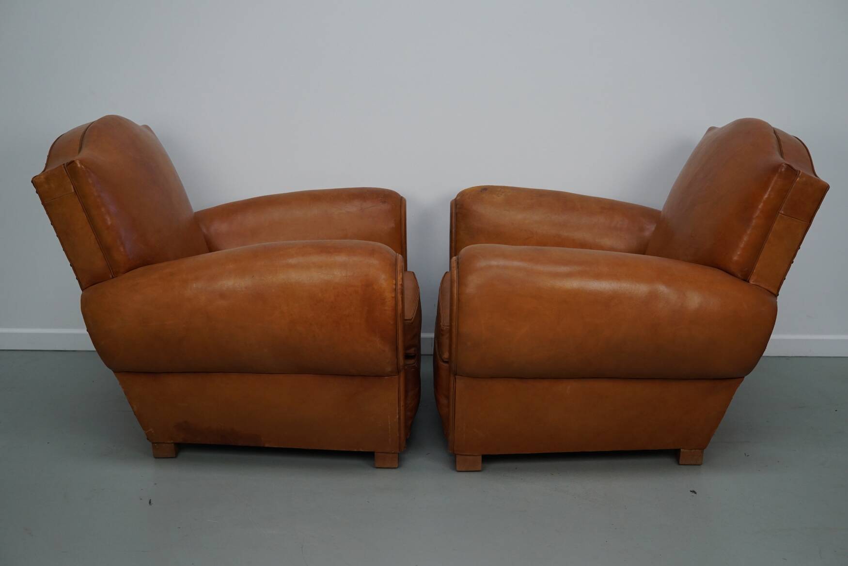 Pair of French club chairs with moustache back in cognac leather, 1950s