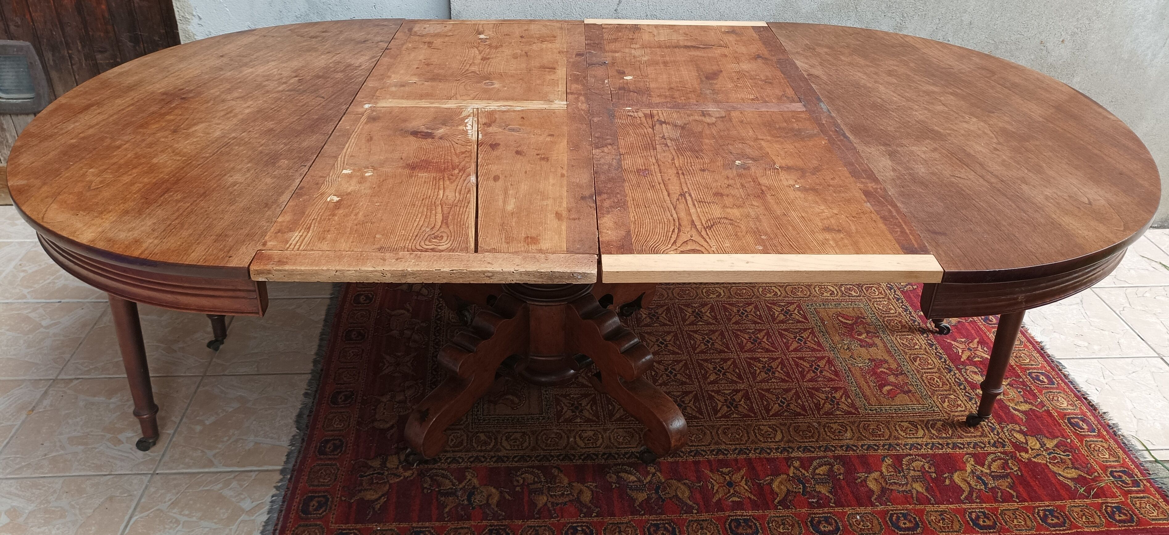 English oval table with 19th century mahogany extensions
