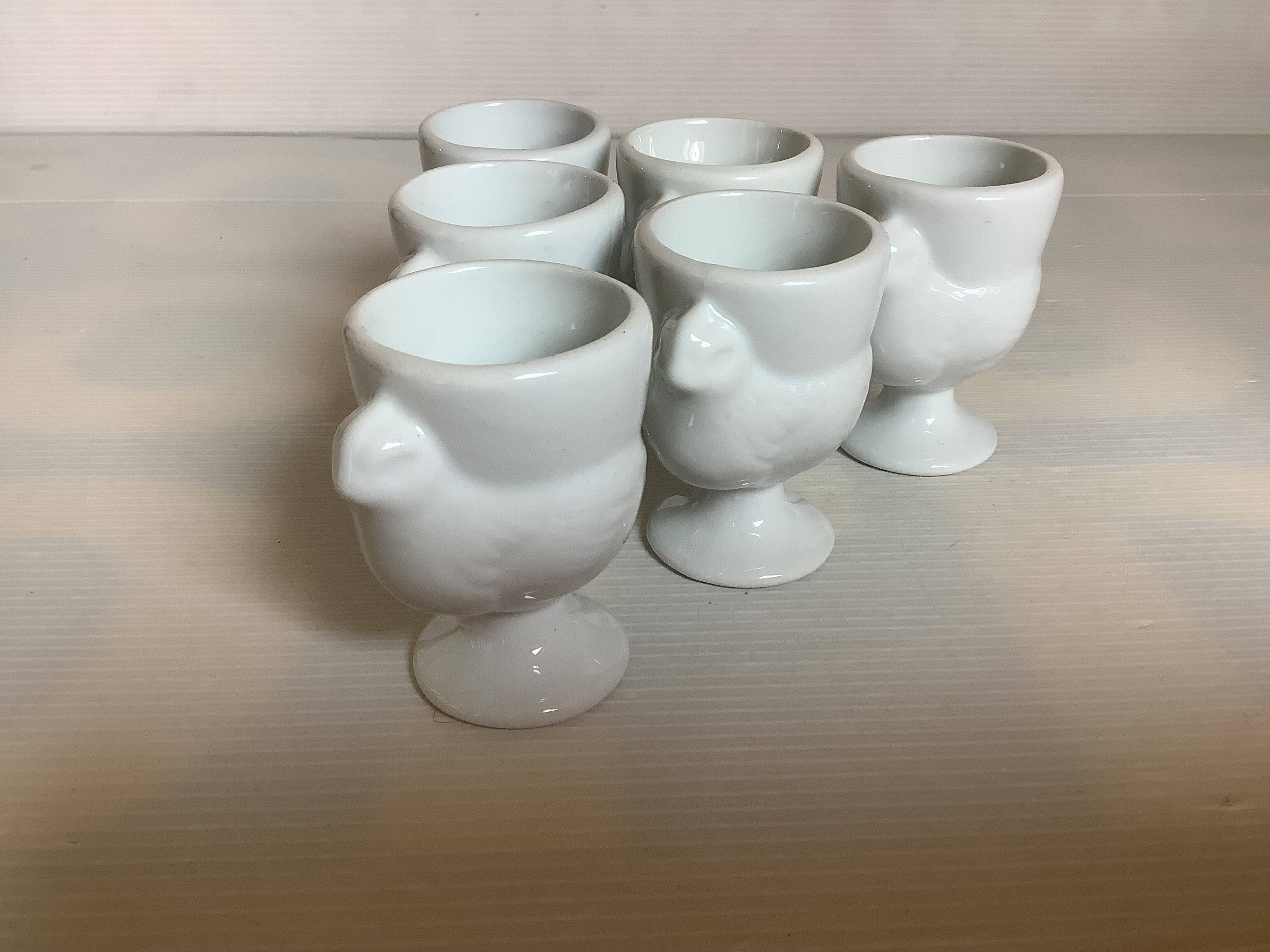 Six white hen egg cups
