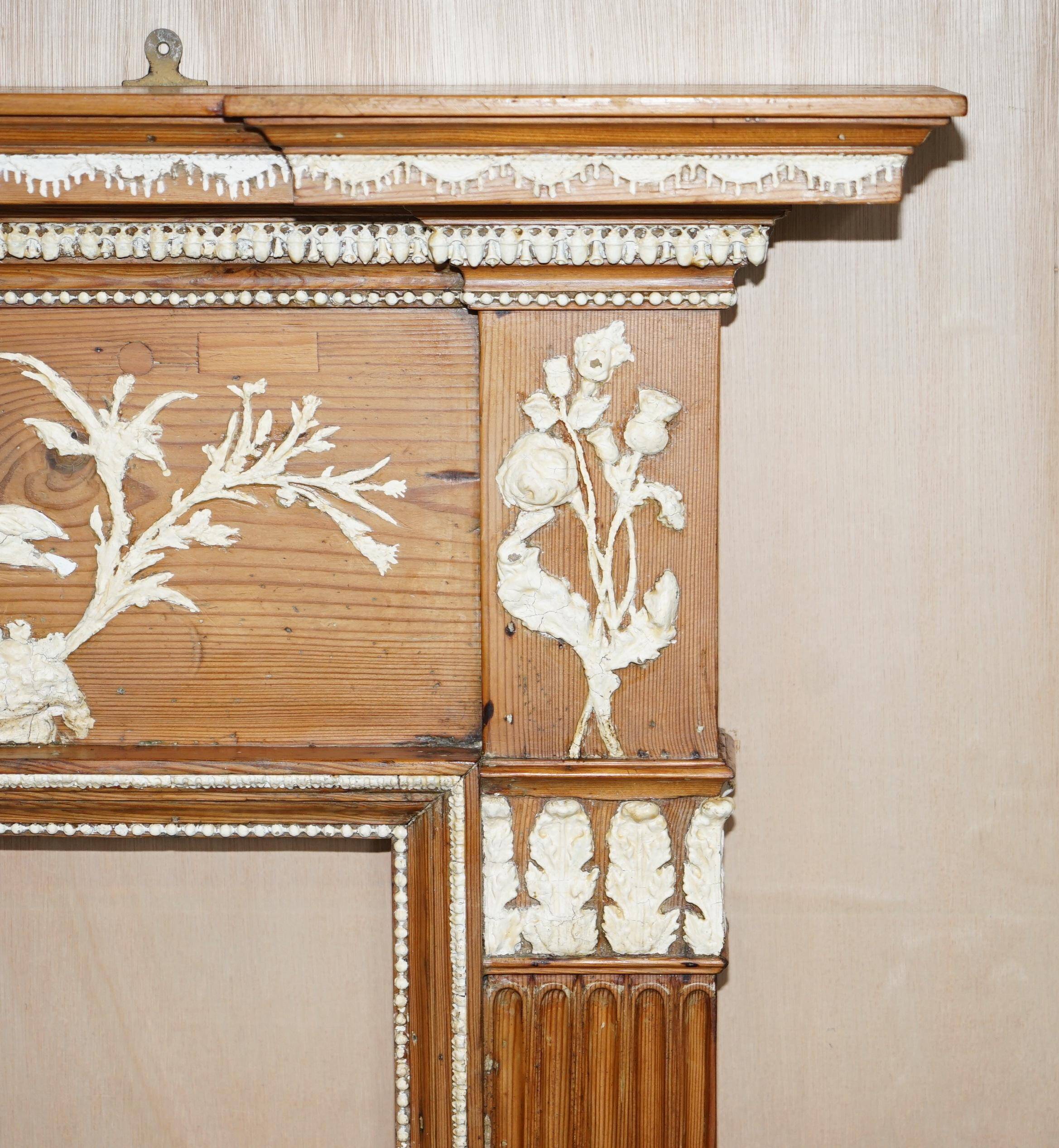 Victorian antique fireplace in tarred pine and sculpted gesso.