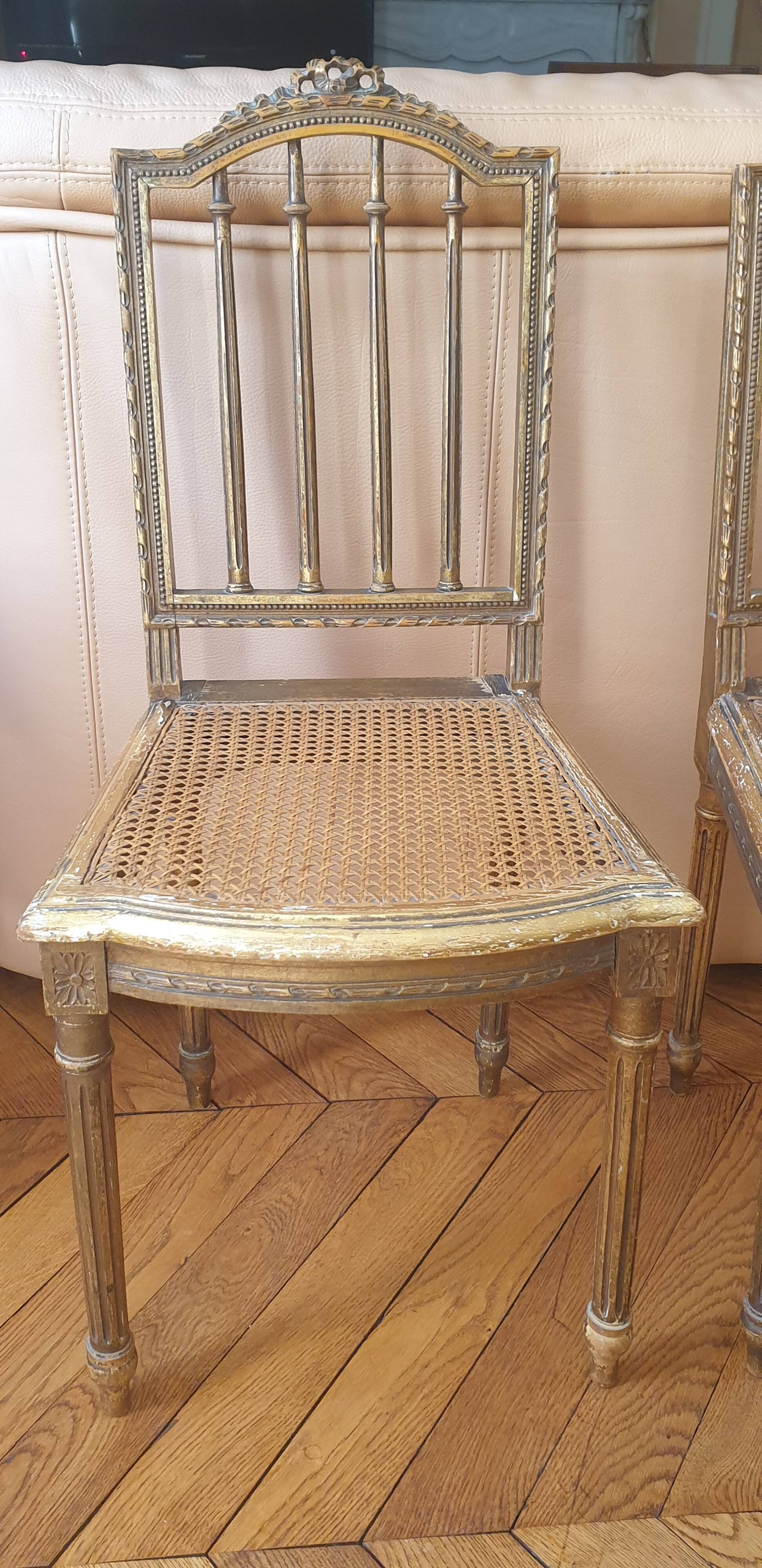 Pair of Louis XVI caned chairs with carved gilded wood.