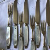 Old brass forks and knives and mother-of-pearl handle