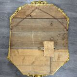 Antique octagonal mirror in richly carved gilded wood, Louis XV style.