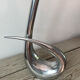 Sculptural vase design in polished aluminium.
