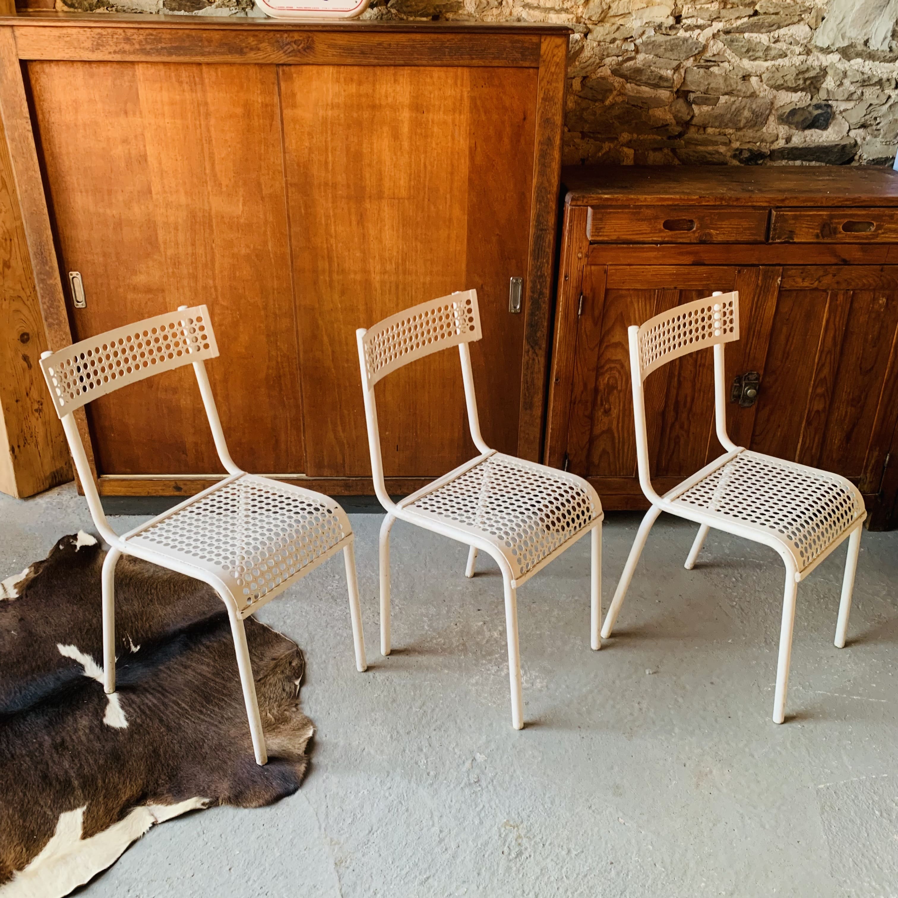 Series of 3 perforated metal chairs