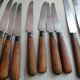 Old table knives and dessert knives, wooden handles, stainless steel blades