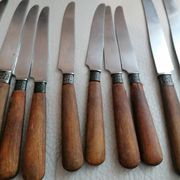 Old table knives and dessert knives, wooden handles, stainless steel blades