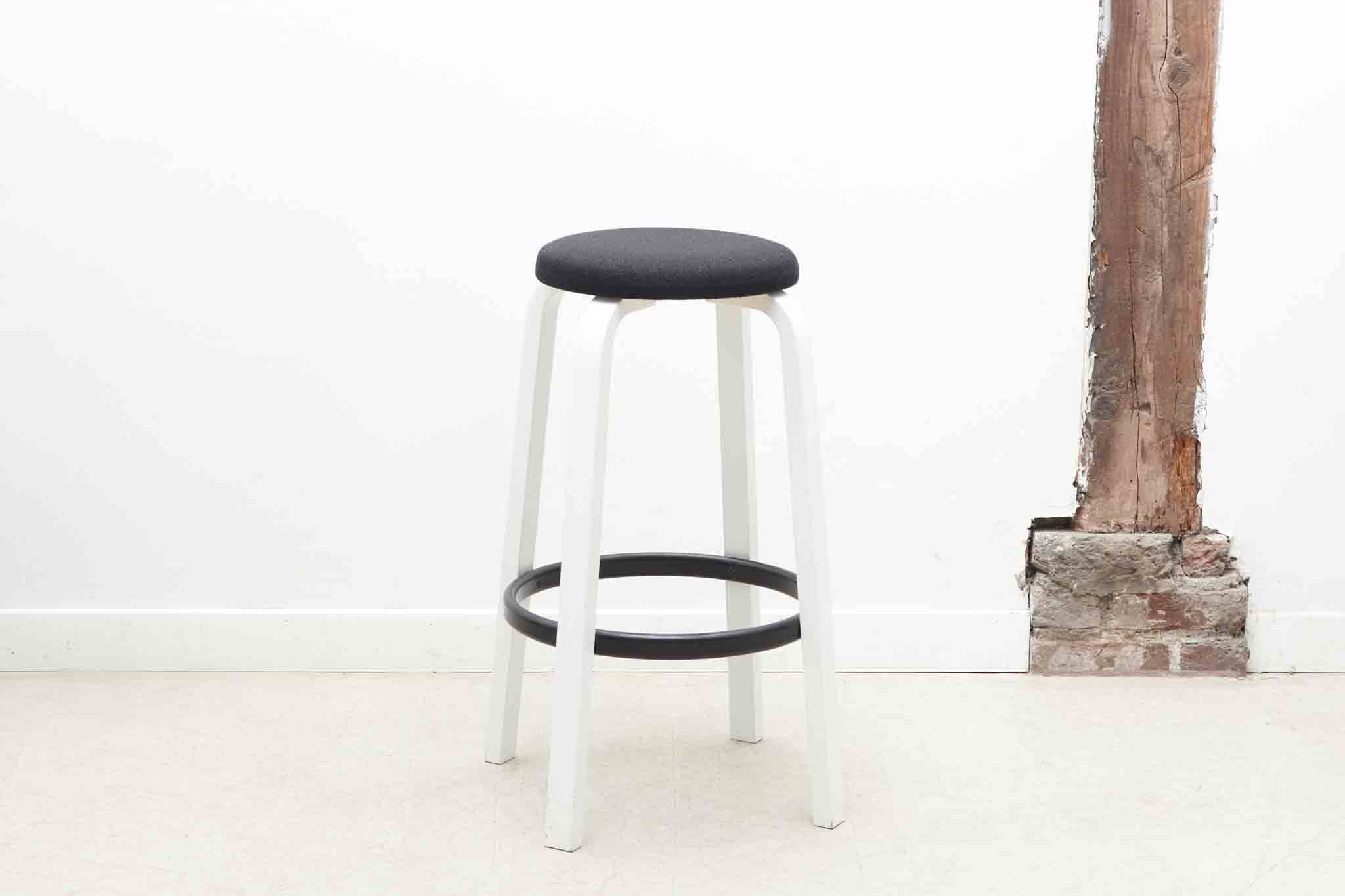 Alvar Aalto 64 stool upholstered in black and white for Artek.