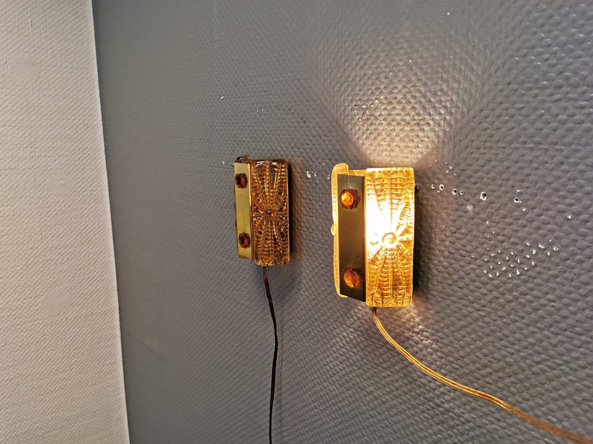 A pair of wall lights with brass-colored suspension with thick pressed glass. Vitrika, Denmark