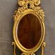 Oval view mirror in gilded wood with leafy decoration in Regency style