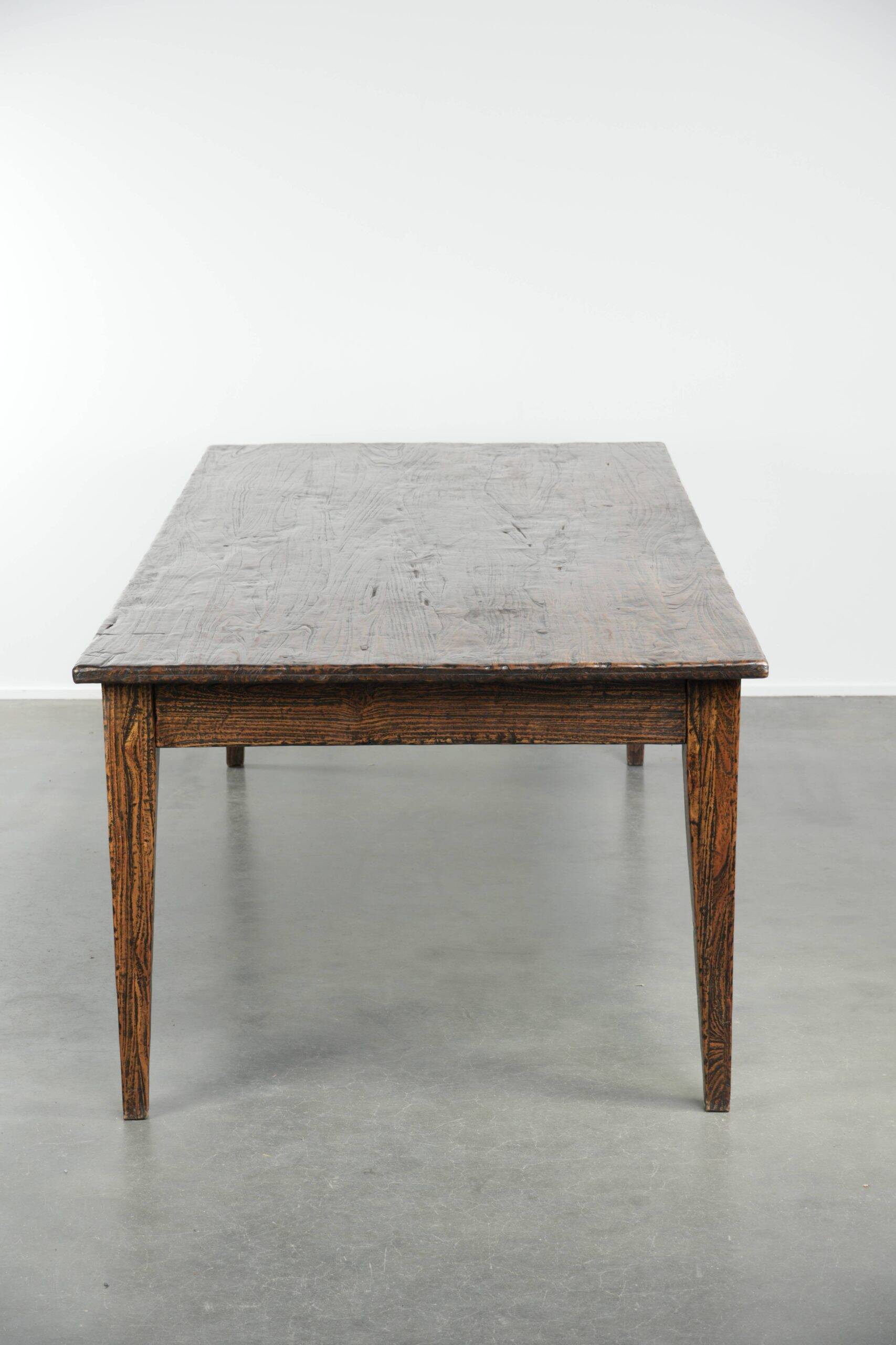 Large rustic dining table made of atmospheric elm wood with fine details