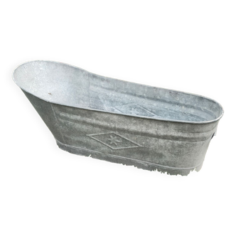 Antique children's bathtub in zinc
