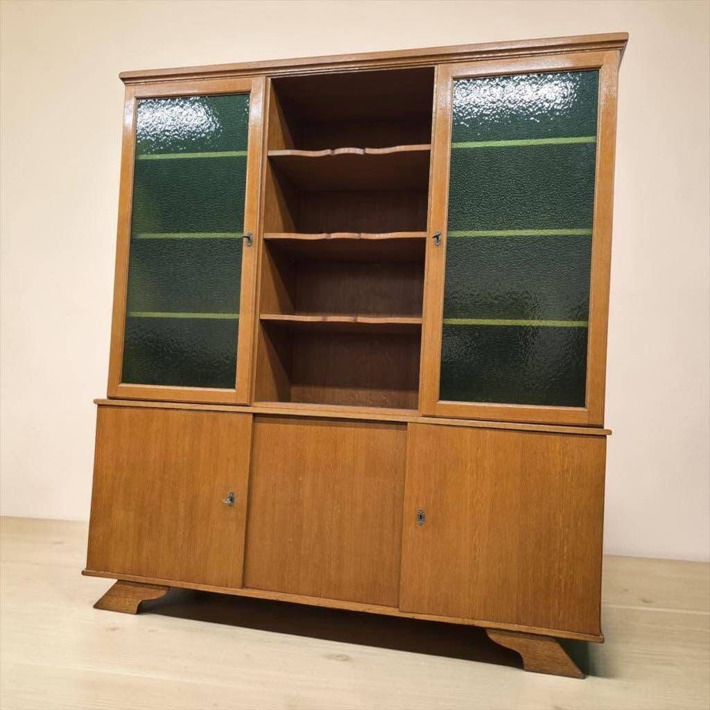 Vintage wooden display cabinet with green glass.