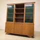 Vintage wooden display cabinet with green glass.