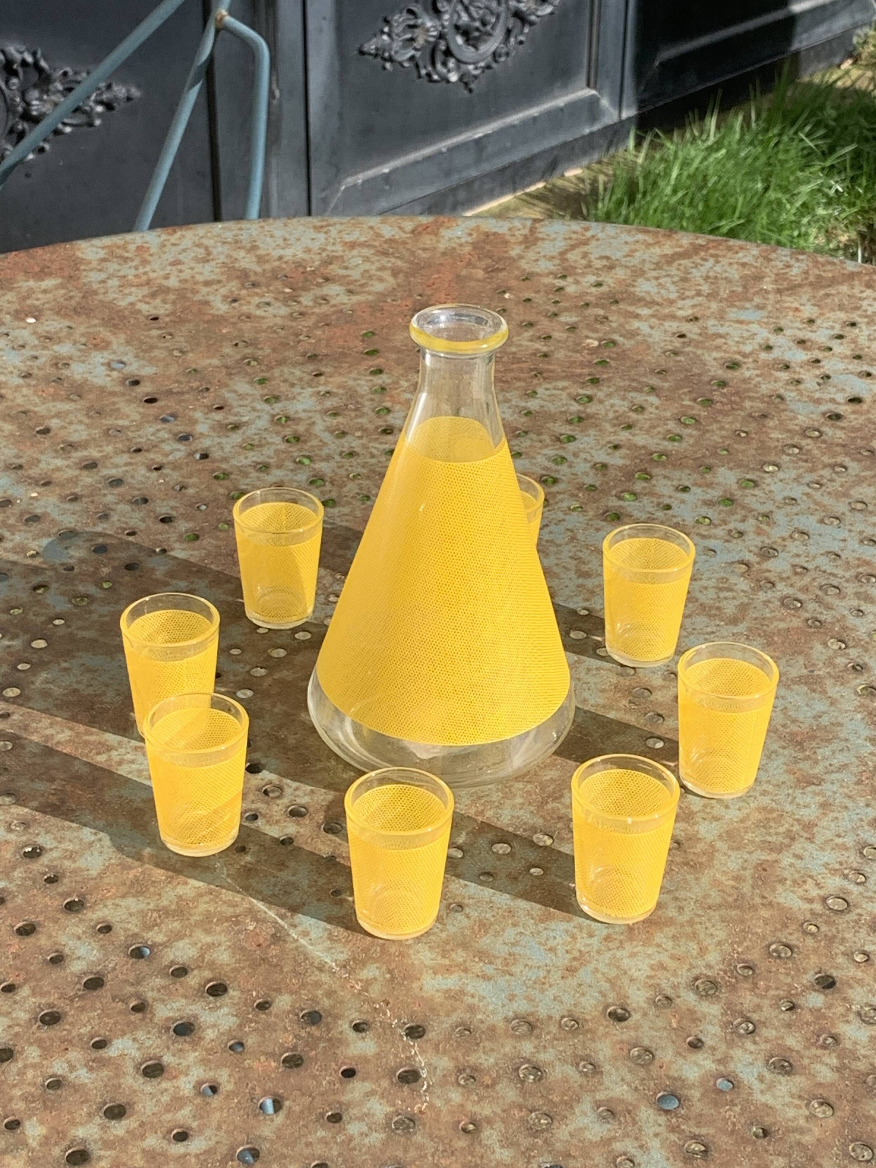 Liqueur service composed of a glass carafe and 8 small yellow screen-printed glasses