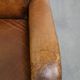 Charming and comfortable vintage armchair in grained cowhide leather with character