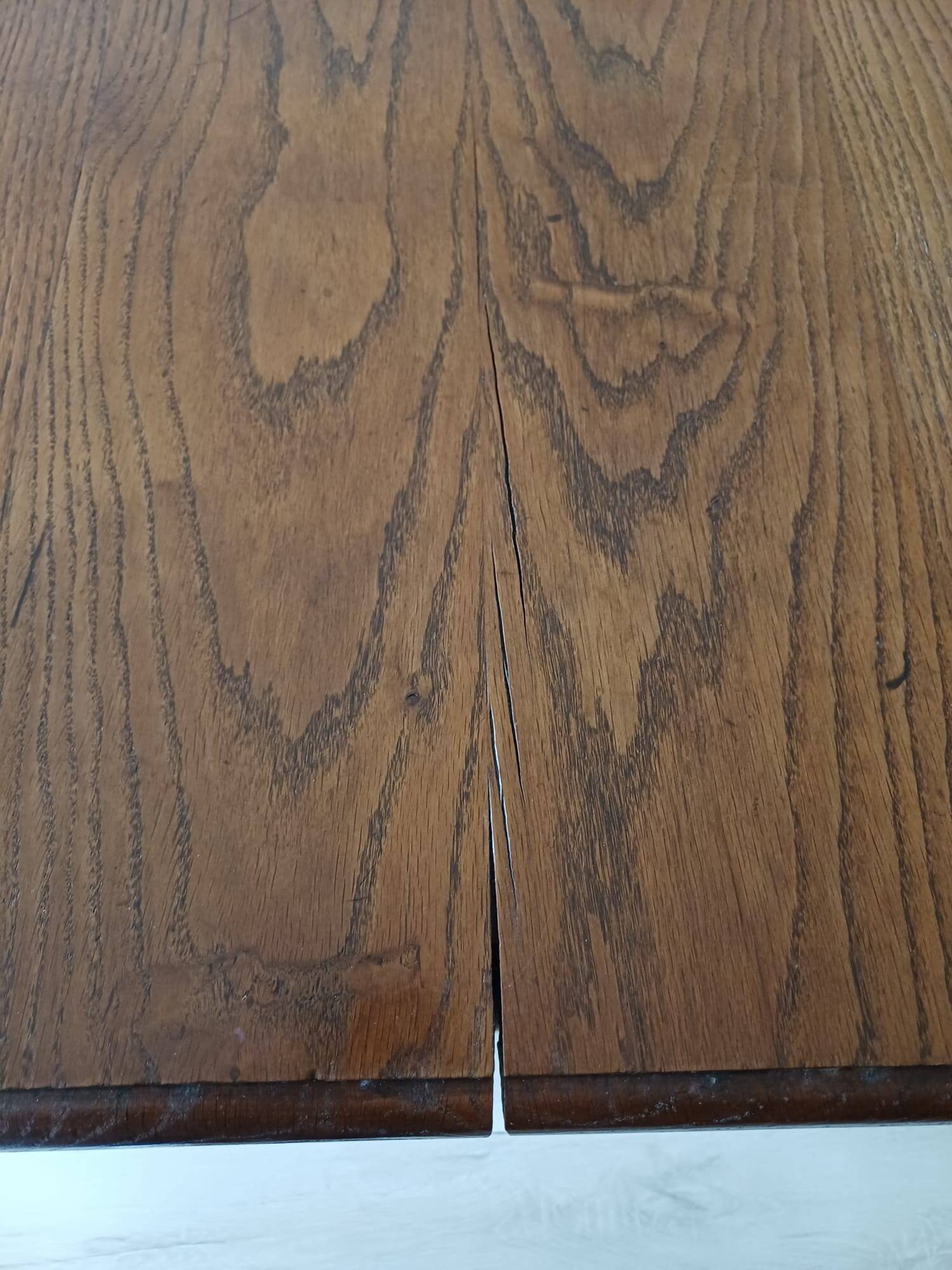 Solid wood dining table with a sculptural base.