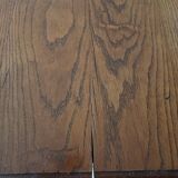 Solid wood dining table with a sculptural base.