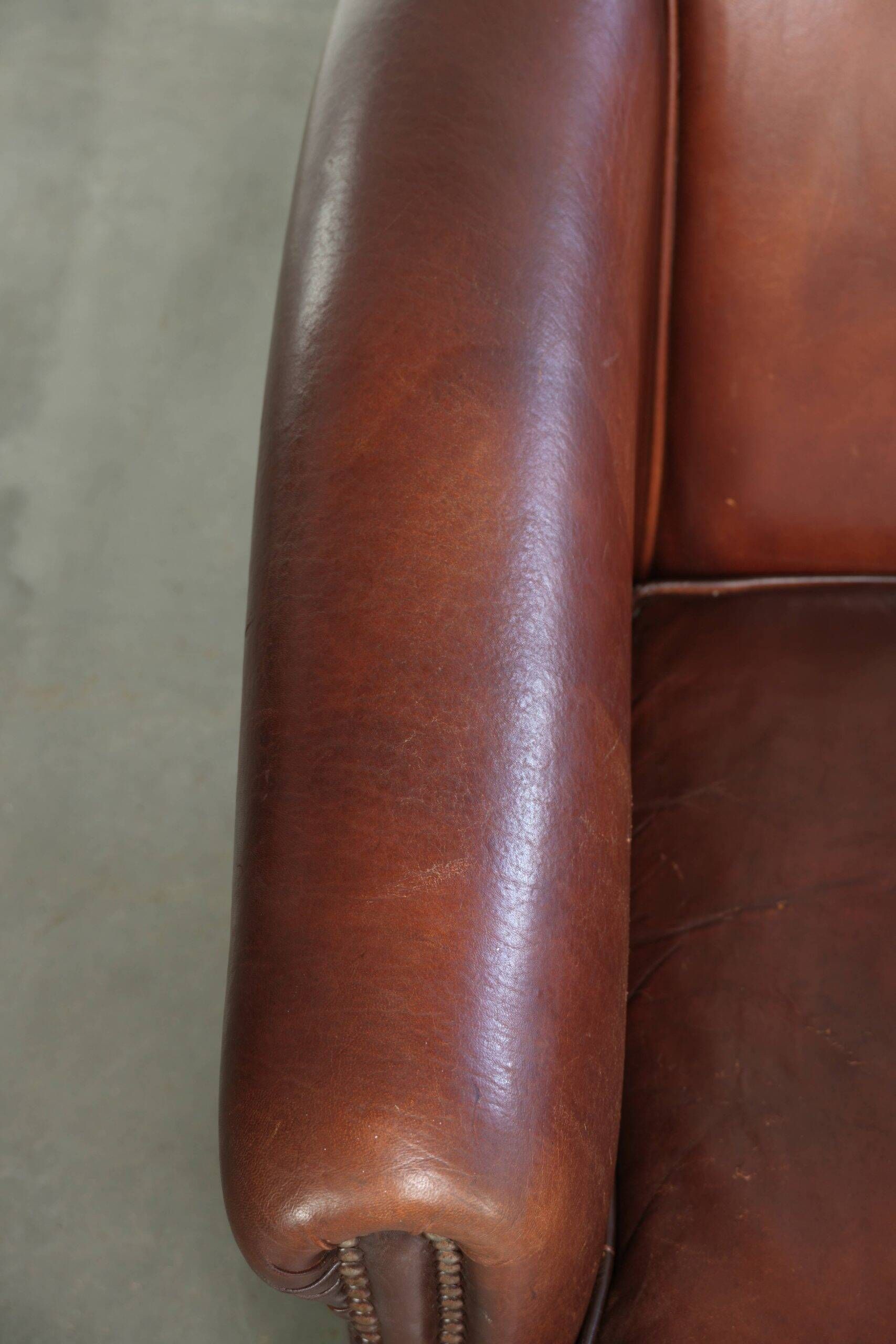 Sheepskin club armchair in English style with brown colour scheme