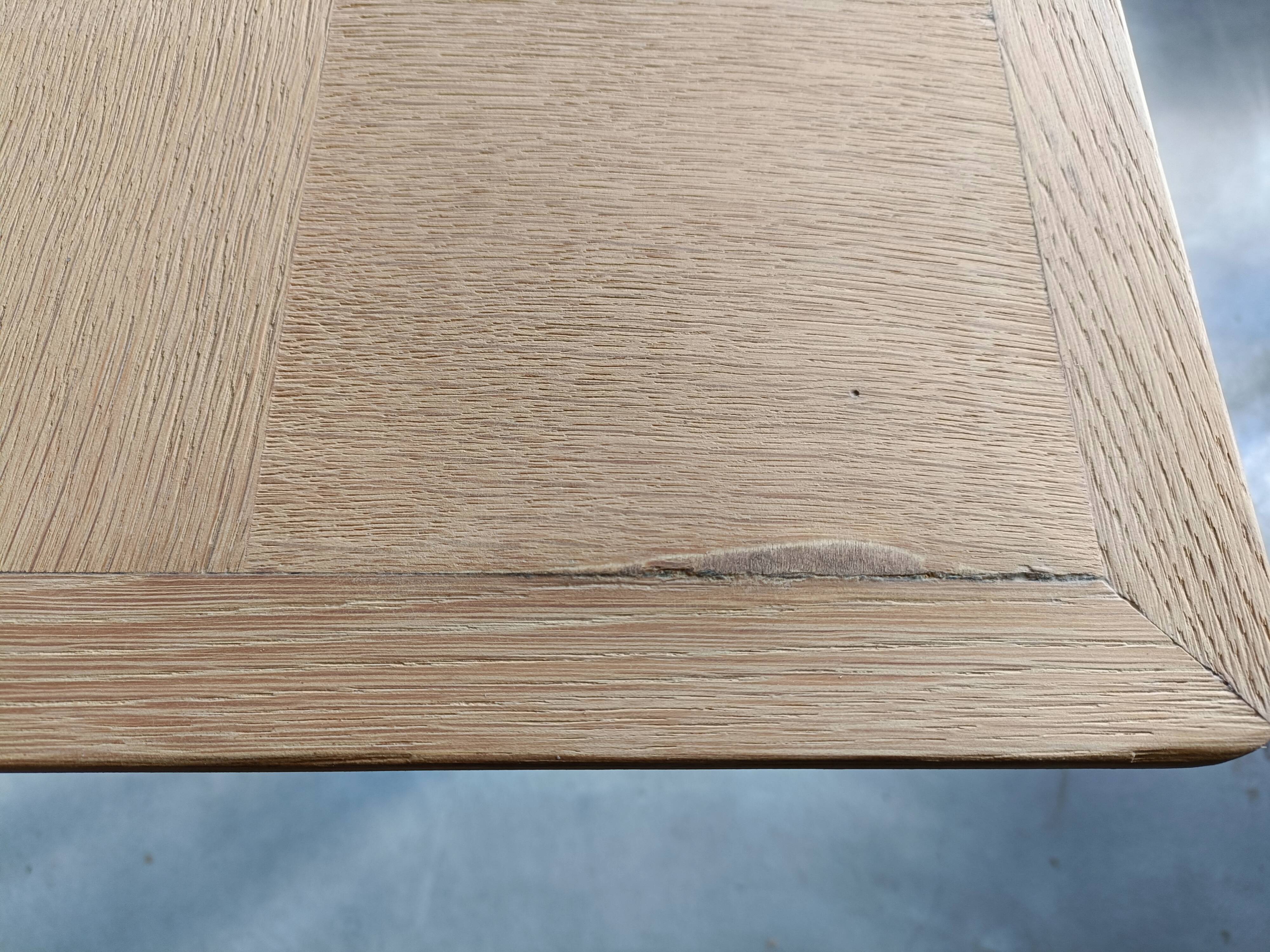 Oak dining table with a checkerboard top and extensions.