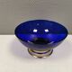 Beautiful blue glass bowl mounted on silver colored base (Original).