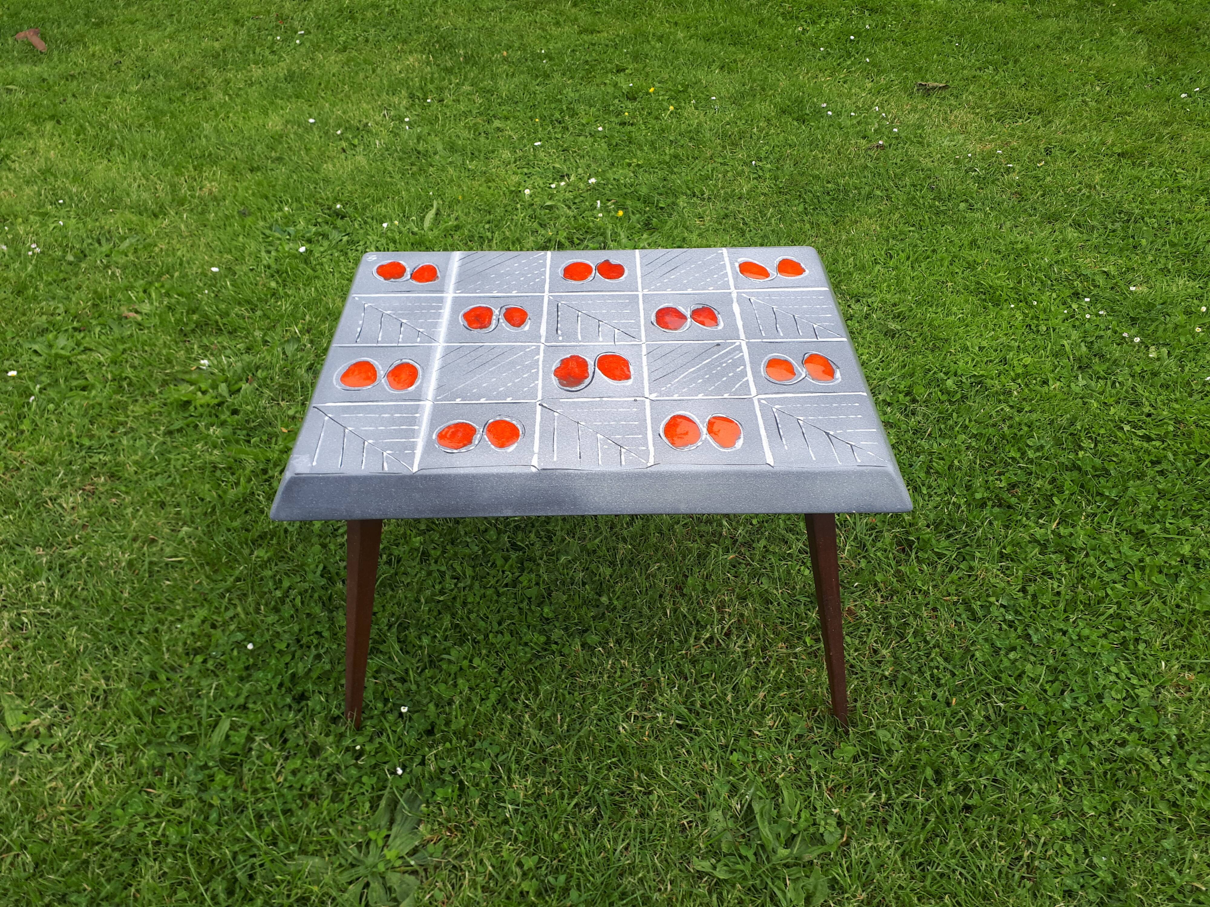 Small 1960s enamelled table, spindle legs, signed jd.
