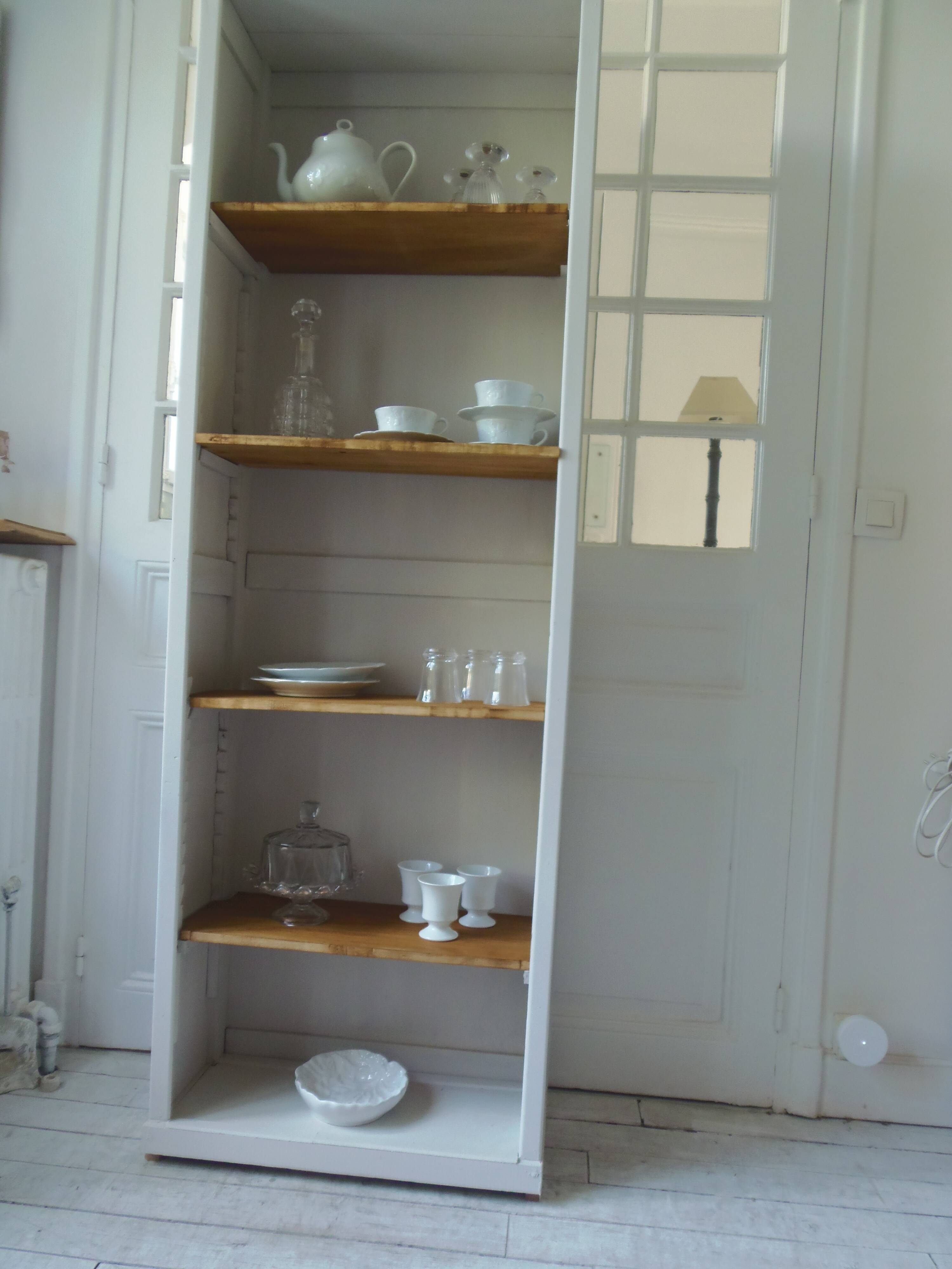 Shallow depth bookcase re-enchanted in pearl gray, wooden shelves.