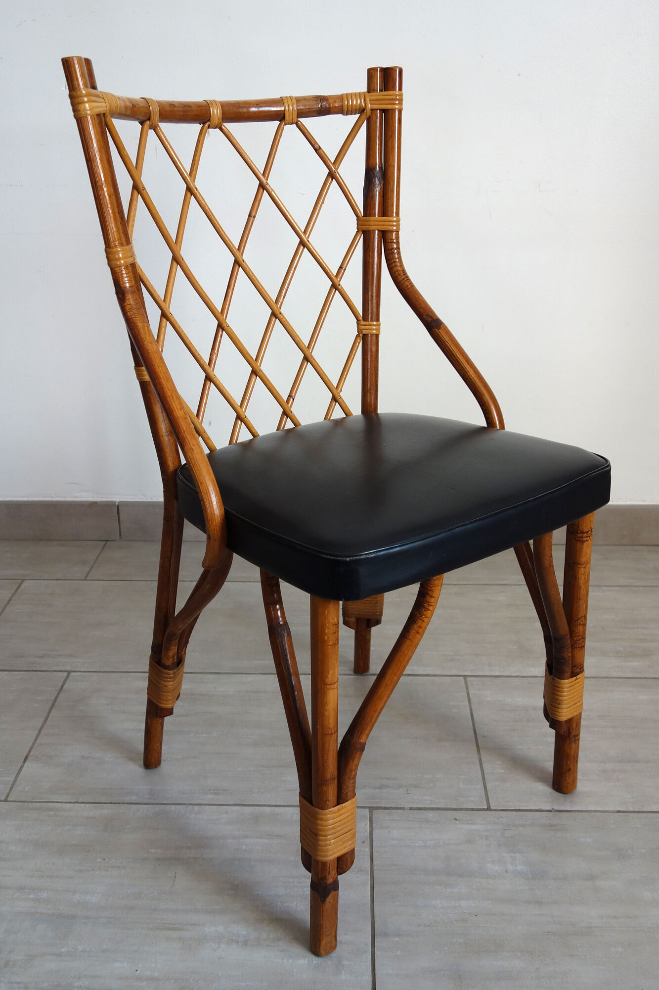 Pair of rattan and black skai bamboo chairs, 60s
