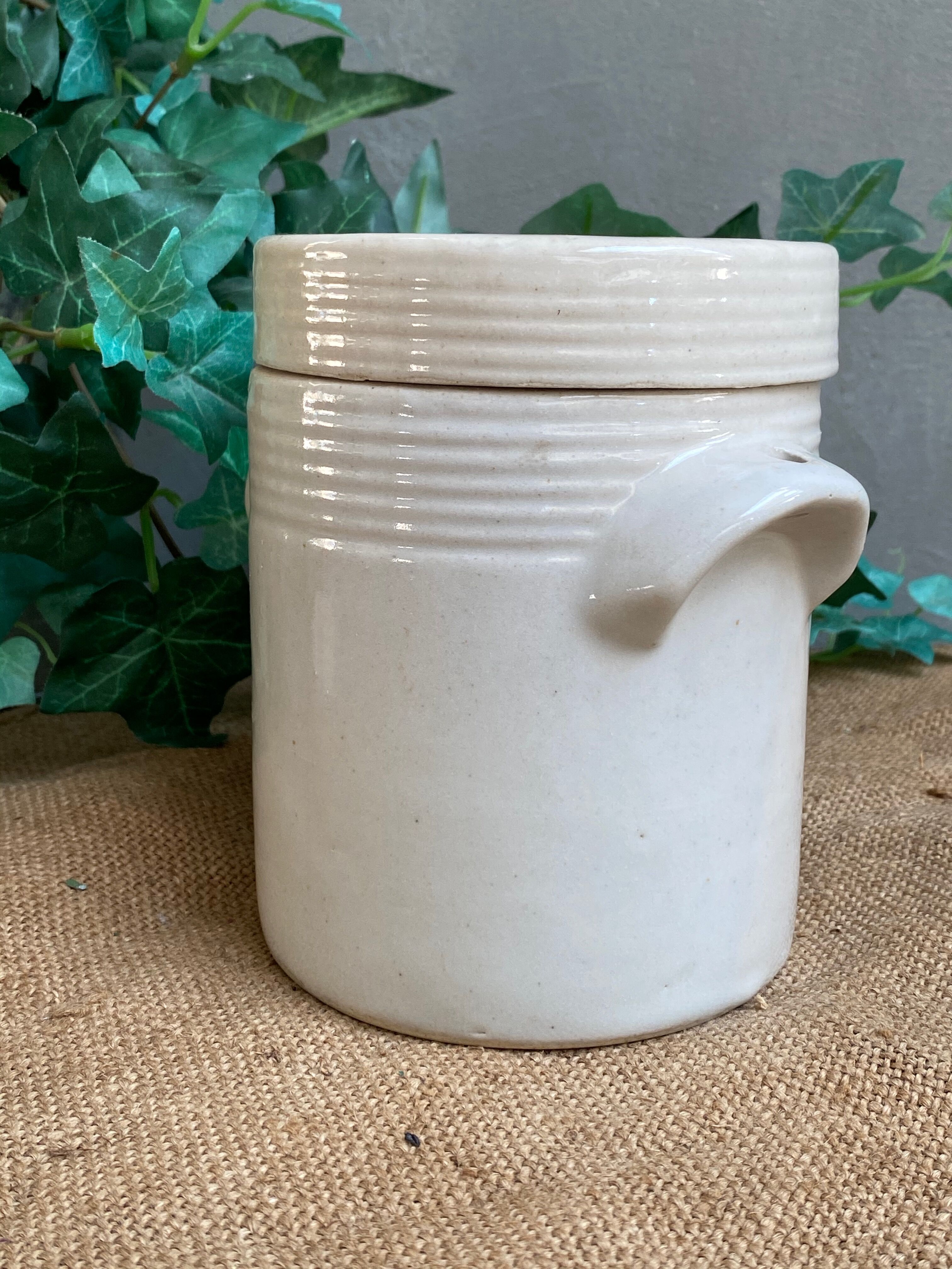 White pot in glazed earth