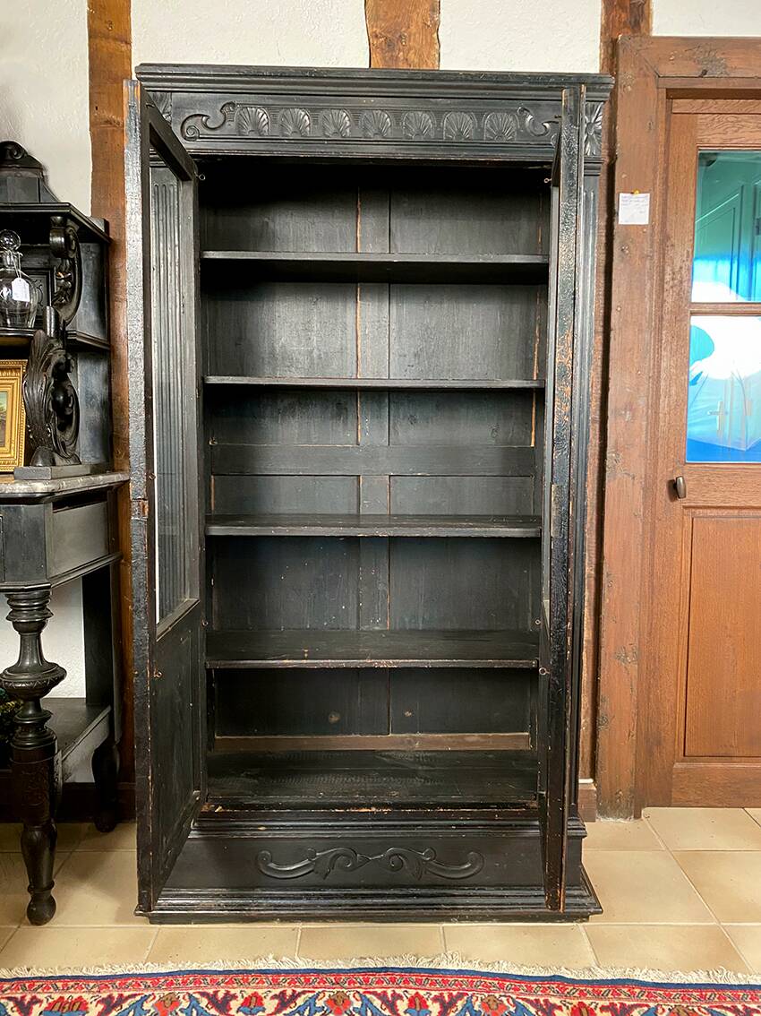 Blackened wooden display cabinet from the late 19th or early 20th century.