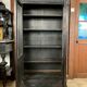 Blackened wooden display cabinet from the late 19th or early 20th century.