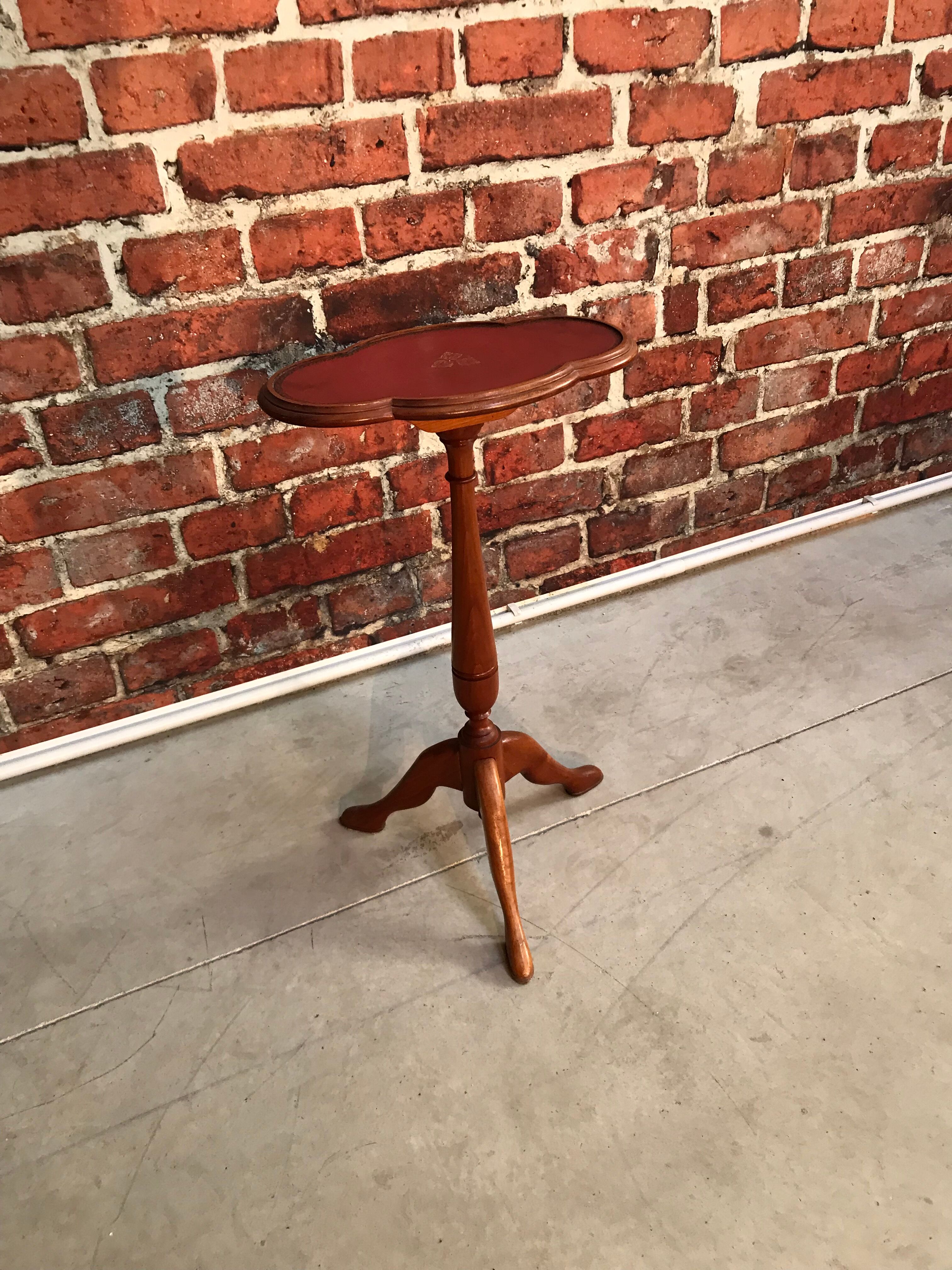 Wooden pedestal table red leather top