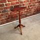 Wooden pedestal table red leather top