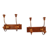 Pair of double coat hooks from the end of the 19th century, circa 1900, in wood and varnished metal