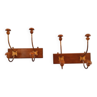 Pair of double coat hooks from the end of the 19th century, circa 1900, in wood and varnished metal